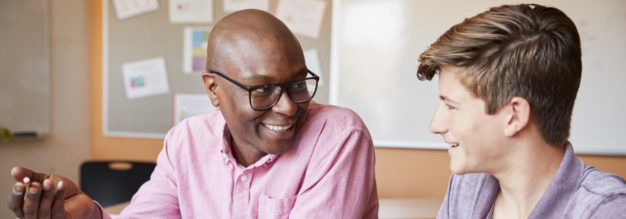 Man tutoring teen boy